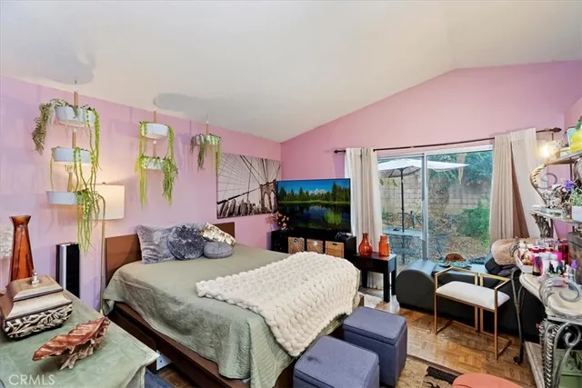 a bedroom with a bed and large windows