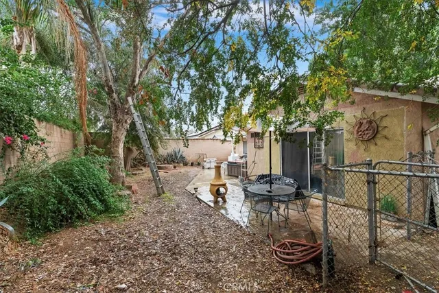 a backyard of a house with table and chairs