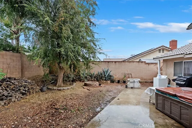 a backyard of a house with table and chairs