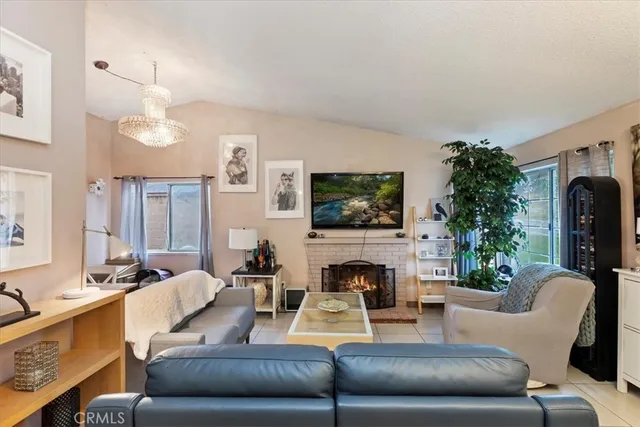 a living room with furniture flat screen tv and a fireplace