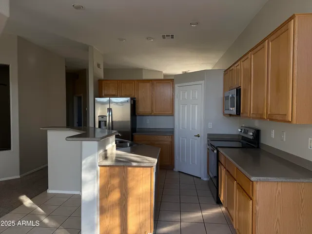 a kitchen that has a sink and a stove in it