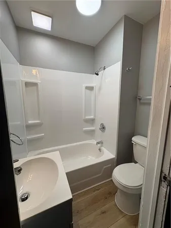 an empty room with wooden floor and closet