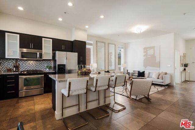 a kitchen with a sink stove and refrigerator
