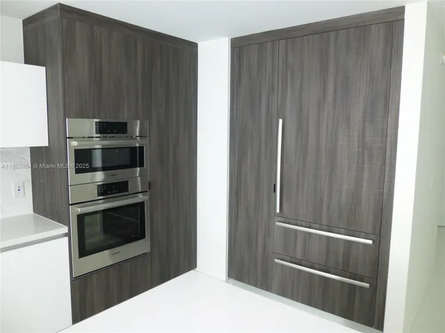 a kitchen with granite countertop cabinets and stainless steel appliances