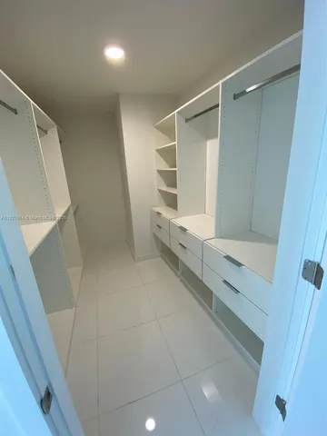 a bathroom with a shower and a sink