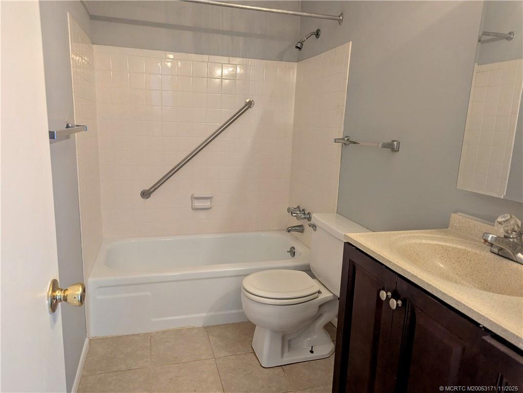 2929 Southeast Ocean Boulevard, Unit 1393 Stuart, FL 34996 - Photo 6 of 9 a bathroom with a sink a toilet and shower