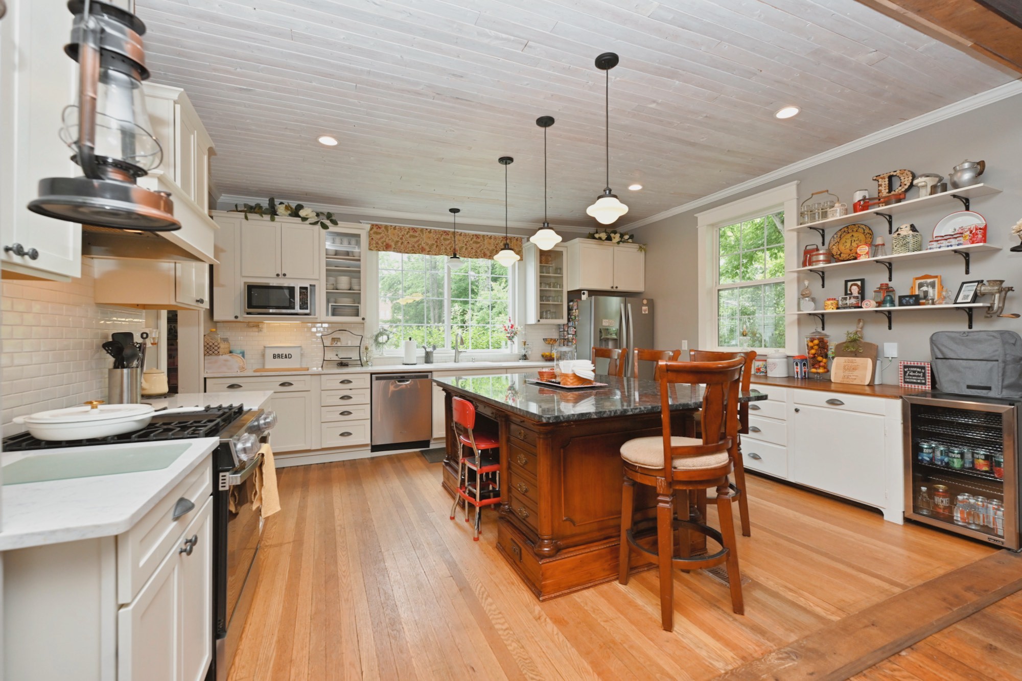 655 East Main Street Gallatin, TN 37066 - Photo 22 of 84 a kitchen with stainless steel appliances granite countertop a stove a sink dishwasher a dining table and chairs with wooden floor