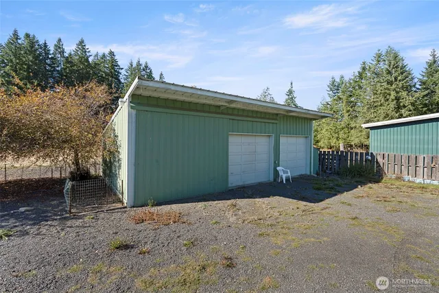 a view of a house with a yard and tree in front of it