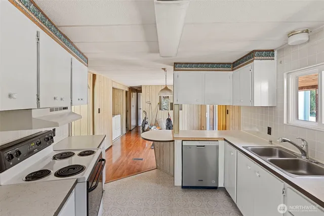 a kitchen with a sink stove and cabinets
