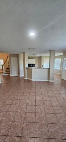 a large kitchen with stainless steel appliances a sink dishwasher stove and cabinets