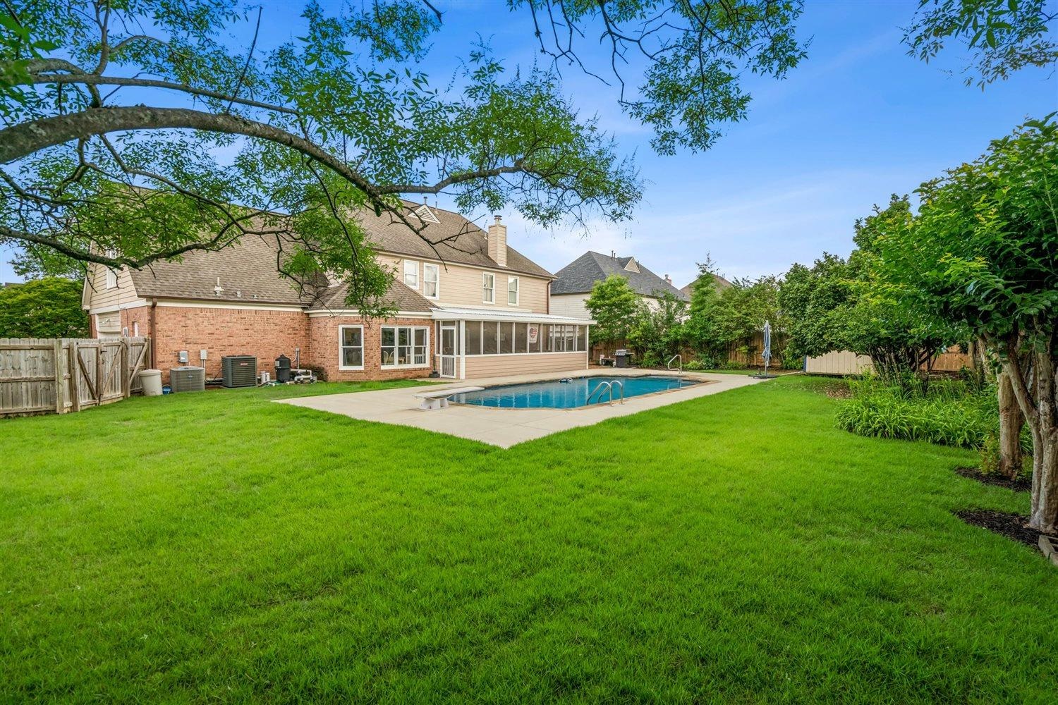 1489 John Ridge Drive Collierville, TN 38017 - Photo 35 of 39 a view of a house with a big yard potted plants and large tree