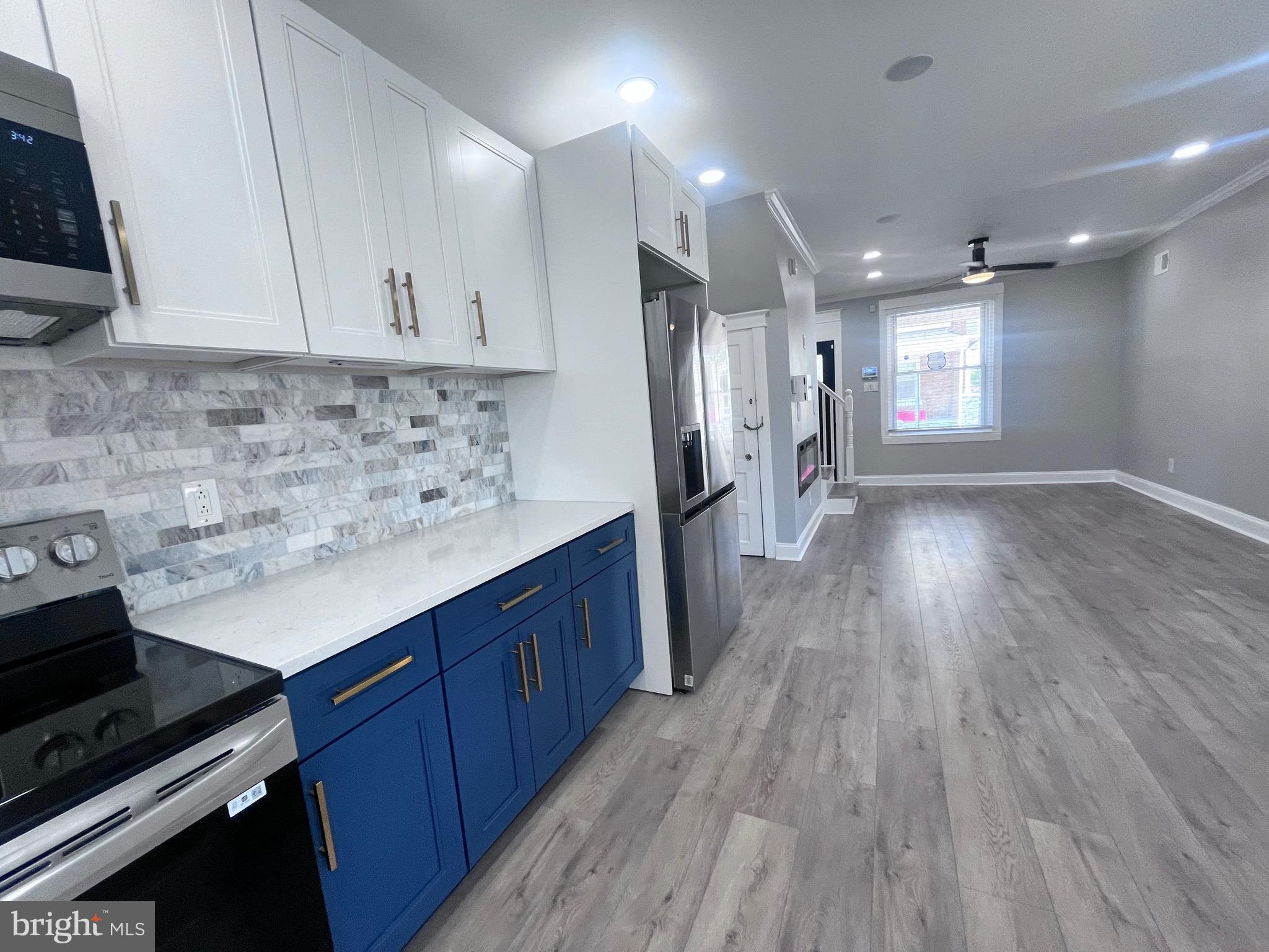 a kitchen with a sink stainless steel appliances and cabinets