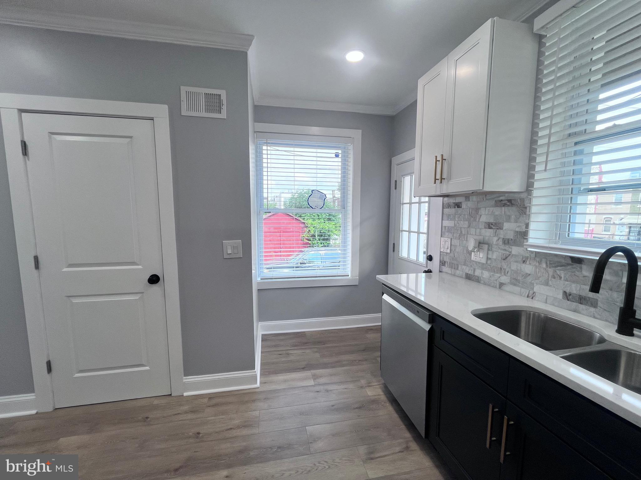 2520 West Seybert Street Philadelphia, PA 19121 - Photo 14 of 40 a kitchen with a sink cabinets and window