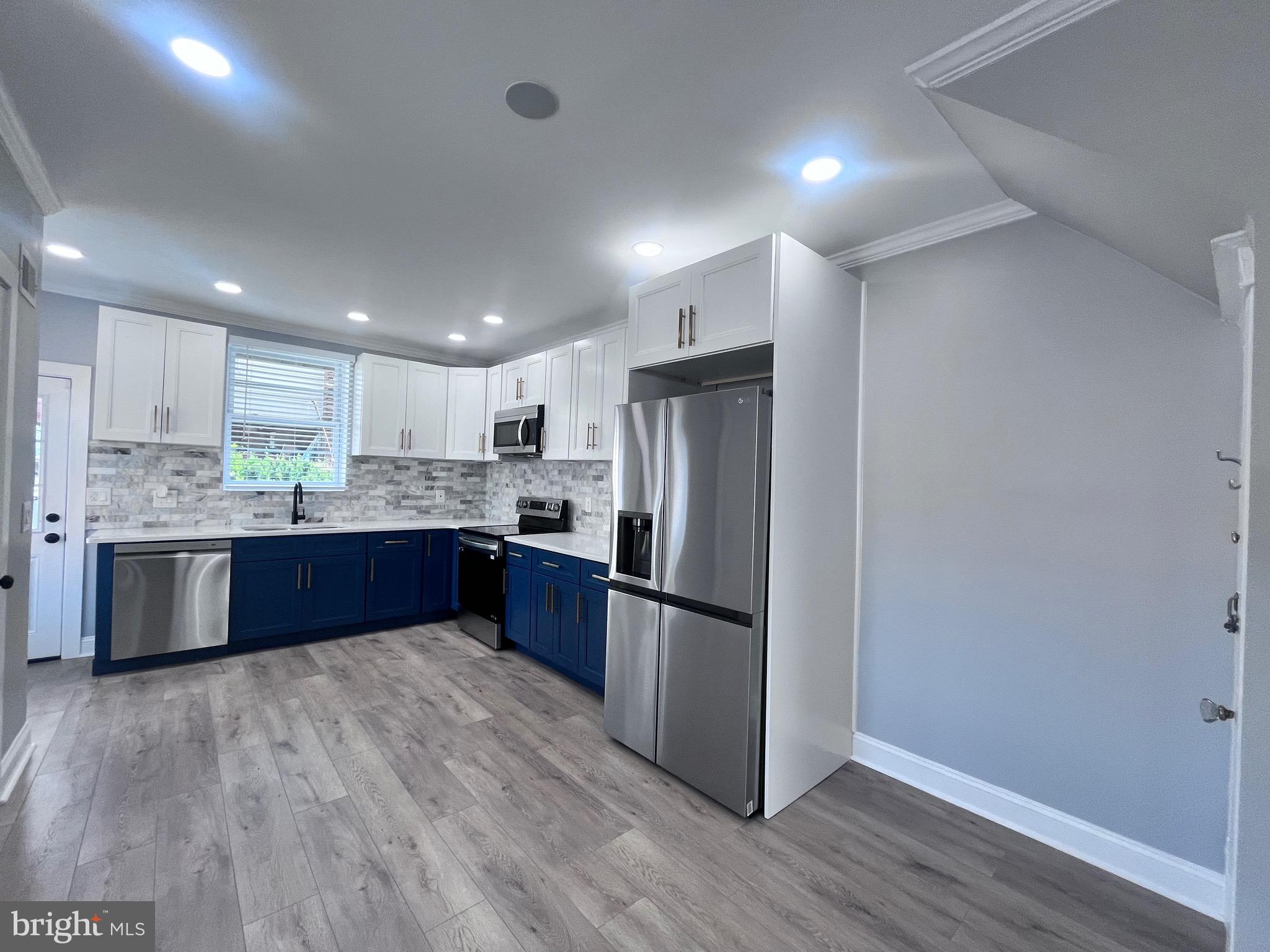 2520 West Seybert Street Philadelphia, PA 19121 - Photo 15 of 40 a large kitchen with stainless steel appliances granite countertop a large counter top a sink and a refrigerator