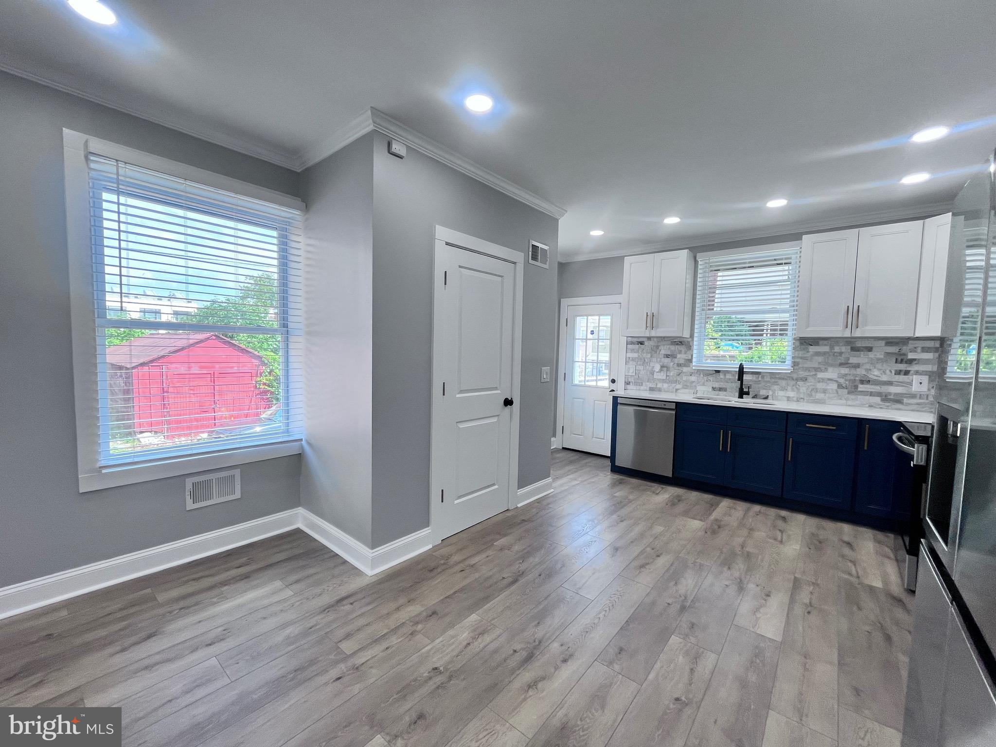 2520 West Seybert Street Philadelphia, PA 19121 - Photo 16 of 40 a kitchen with stainless steel appliances granite countertop a sink dishwasher a refrigerator and wooden floor