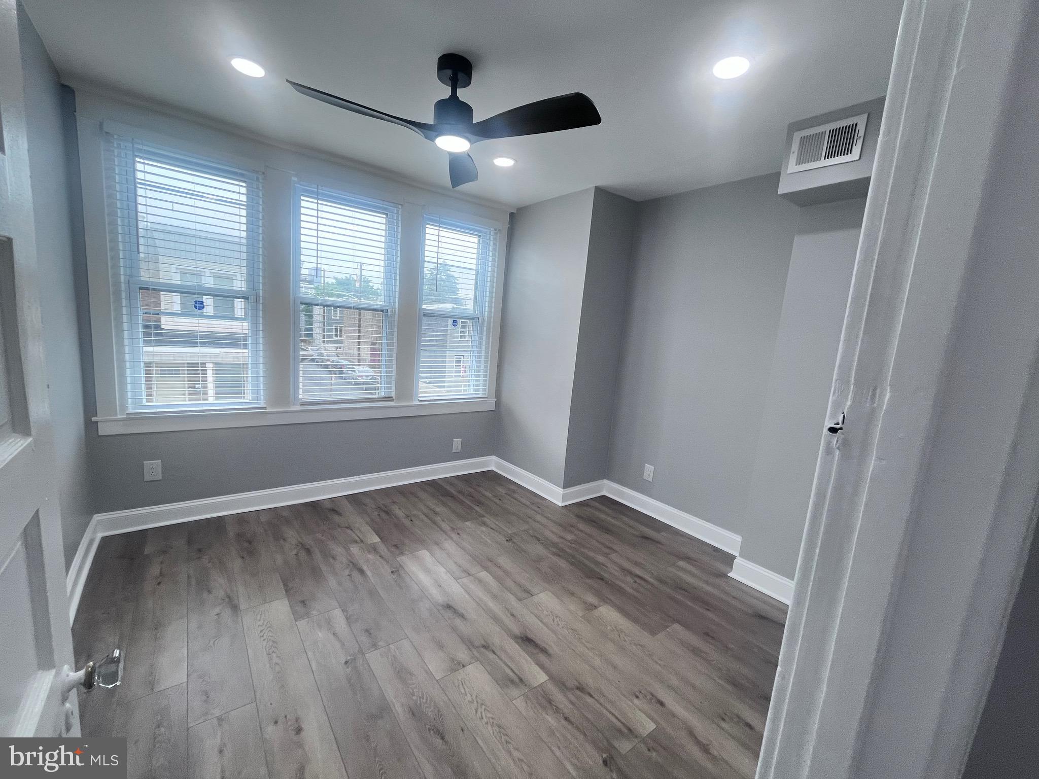 2520 West Seybert Street Philadelphia, PA 19121 - Photo 24 of 40 an empty room with wooden floor and windows