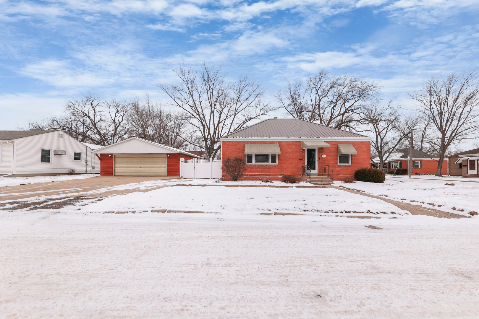 1428 Pickwick Street Ottawa, IL 61350 - Photo 1 of 14 a front view of a house with a yard covered with snow