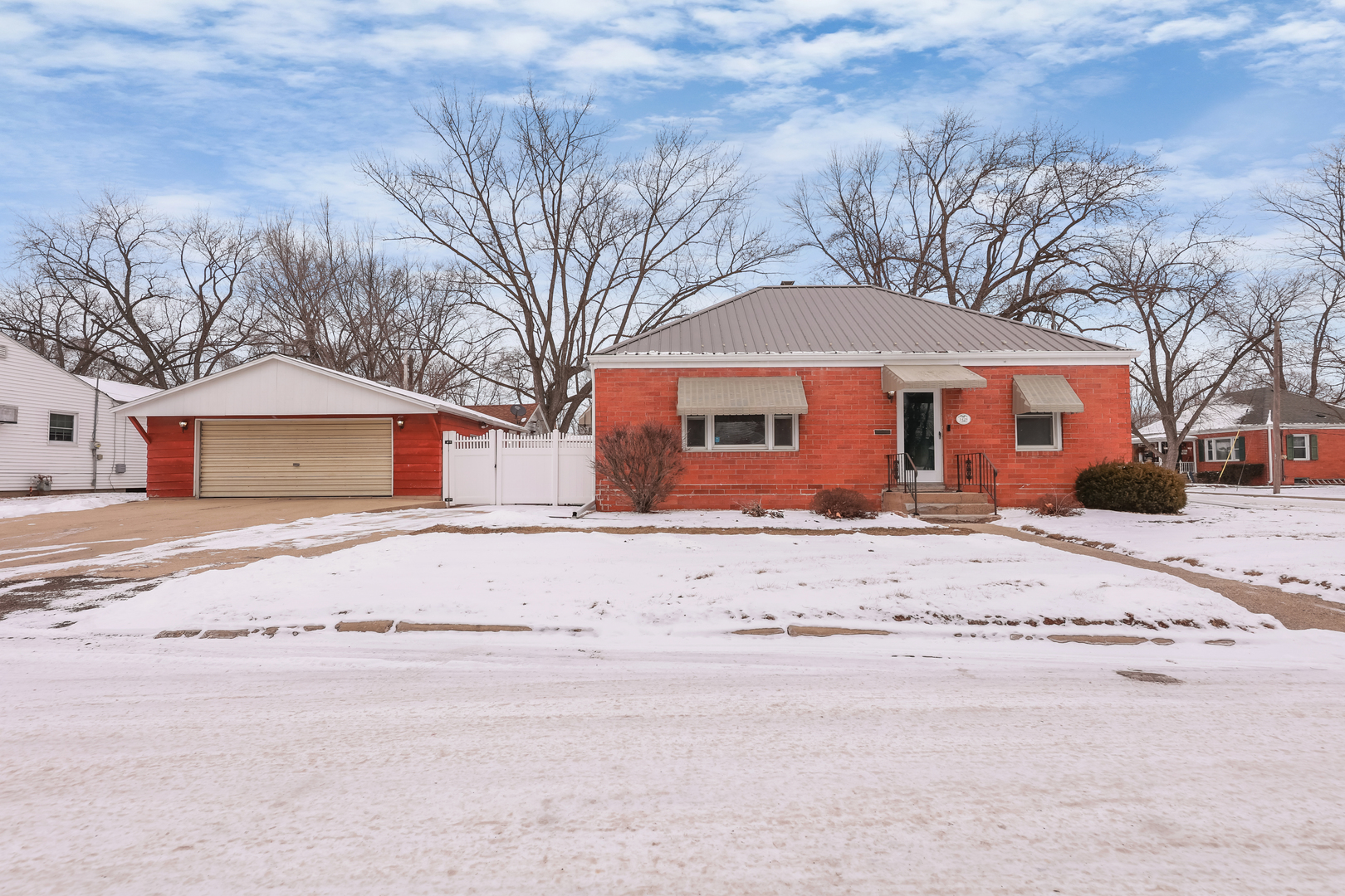 1428 Pickwick Street Ottawa, IL 61350 - Photo 2 of 14 a front view of a house with a road covered with snow