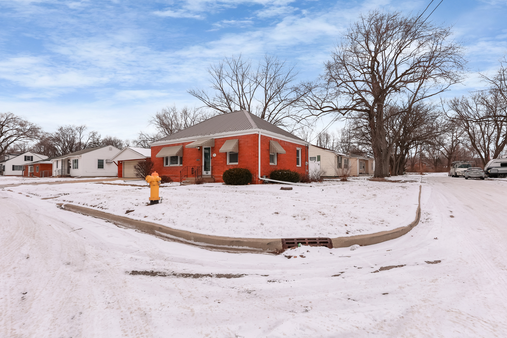 1428 Pickwick Street Ottawa, IL 61350 - Photo 3 of 14 a view of white house with a yard covered in snow