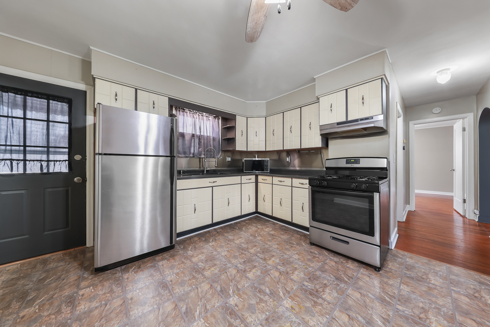 1428 Pickwick Street Ottawa, IL 61350 - Photo 8 of 14 a kitchen with white cabinets and white appliances