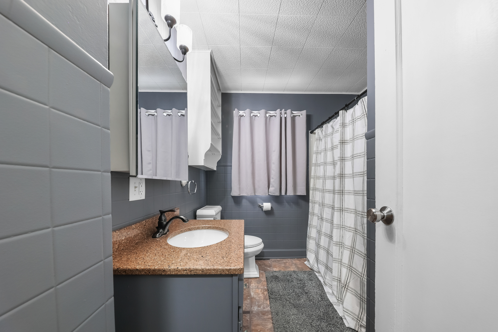 1428 Pickwick Street Ottawa, IL 61350 - Photo 10 of 14 a bathroom with a granite countertop sink and a mirror