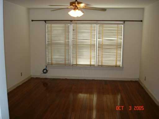 Undisclosed Address Corpus Christi, TX 78404 - Photo 2 of 8 a view of an empty room with wooden floor and a window