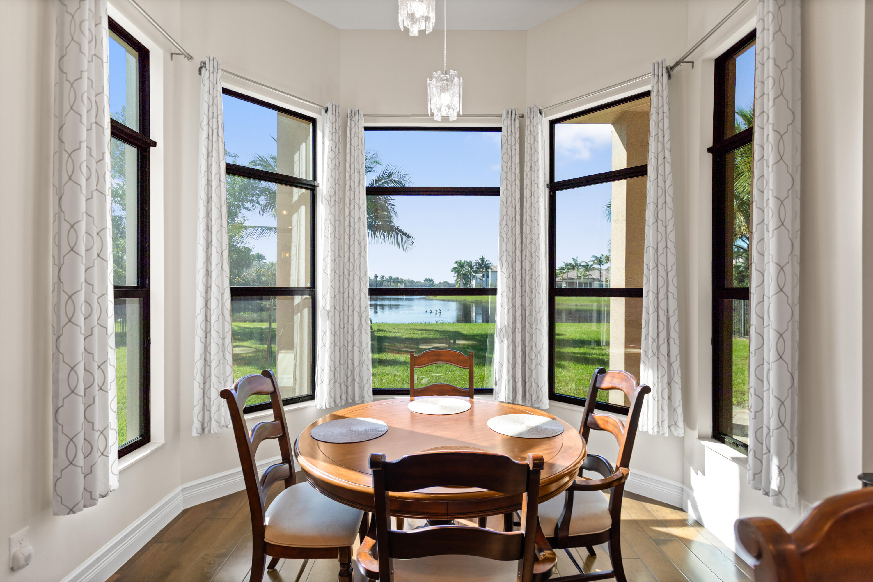16743 Picardy Way Delray Beach, FL 33446 - Photo 12 of 79 a view of a dining room with furniture window and wooden floor