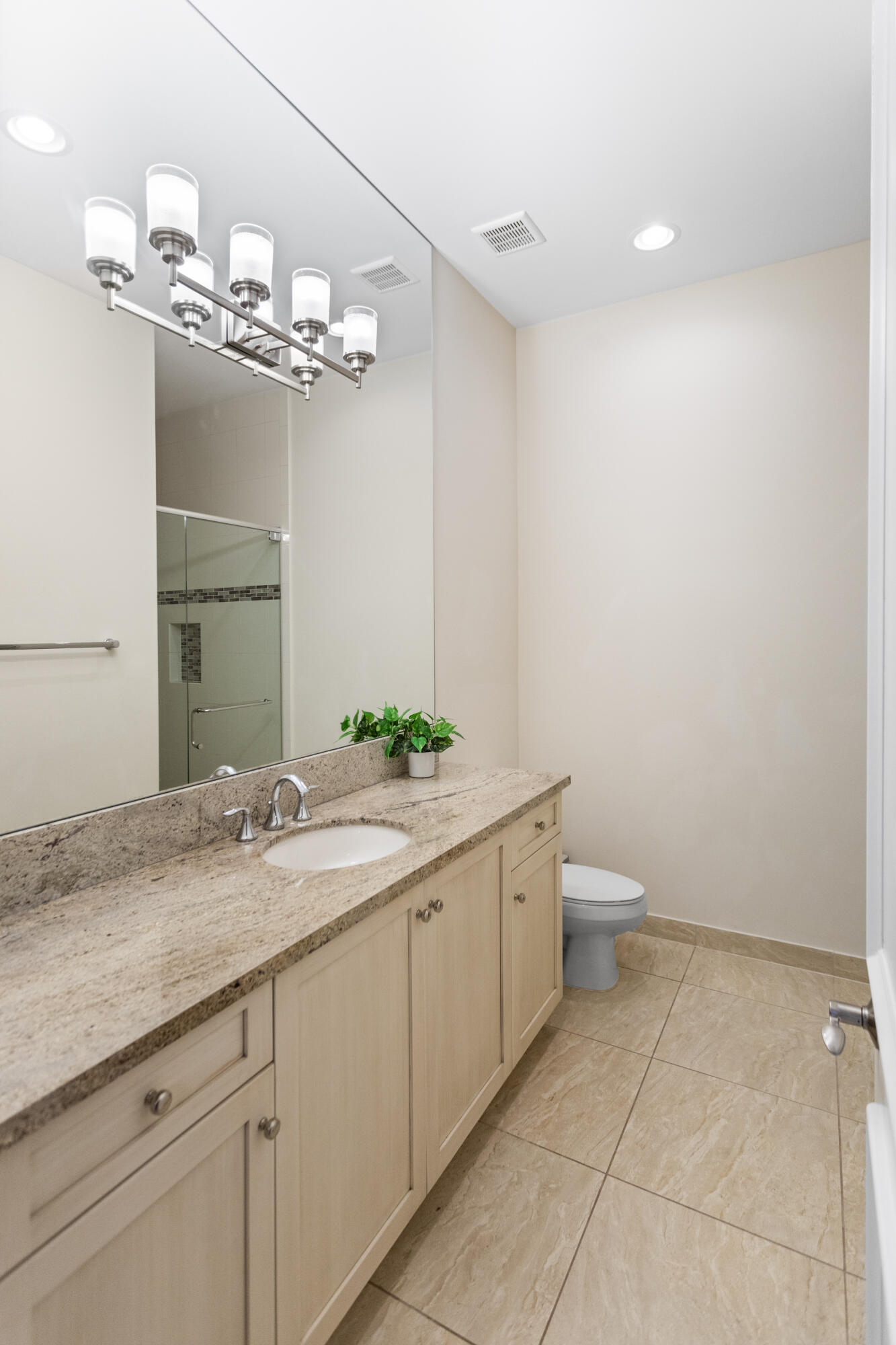 16743 Picardy Way Delray Beach, FL 33446 - Photo 45 of 79 a spacious bathroom with a granite countertop sink a toilet and a mirror