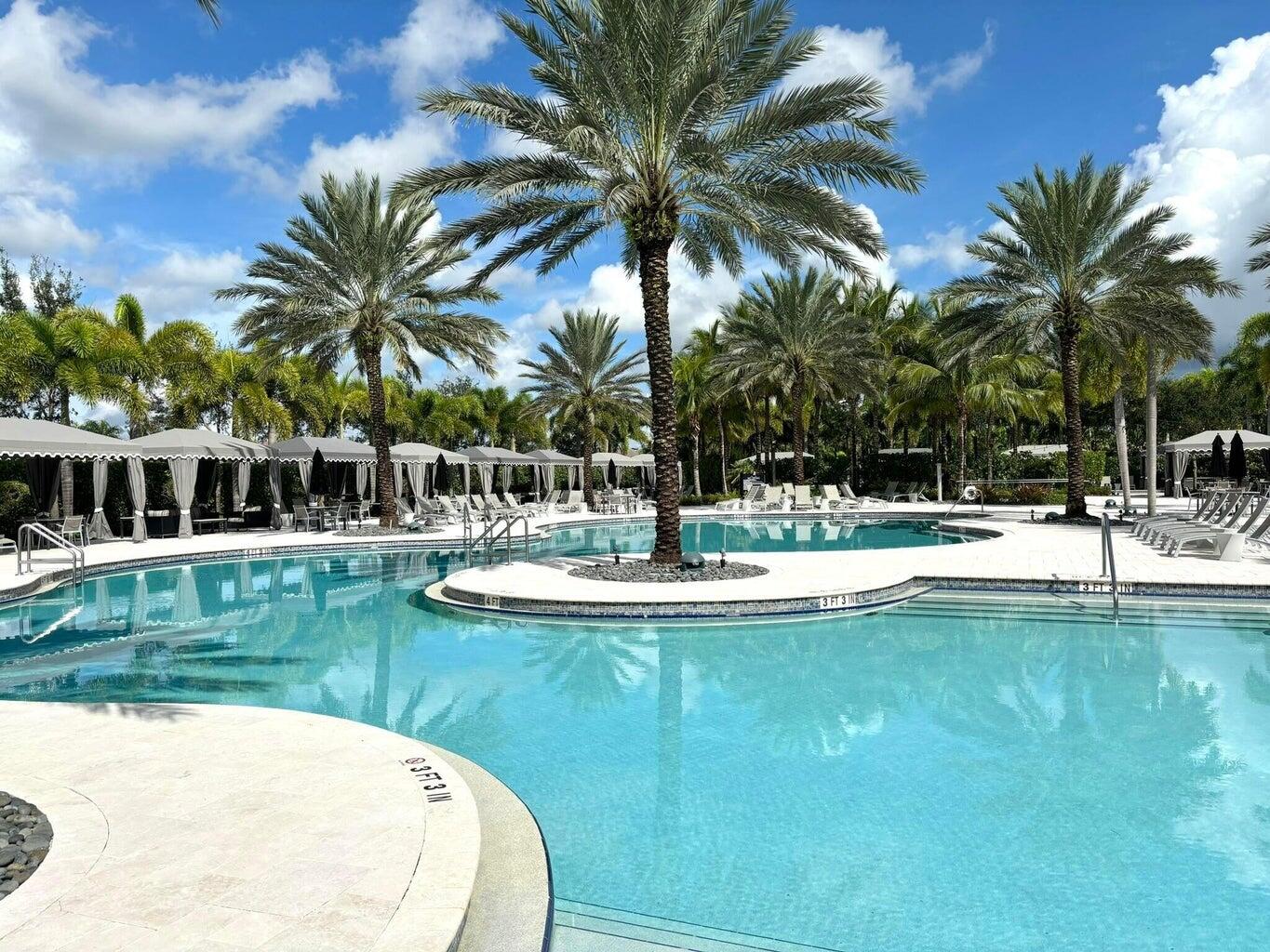 16743 Picardy Way Delray Beach, FL 33446 - Photo 76 of 79 a view of a swimming pool with a garden and trees