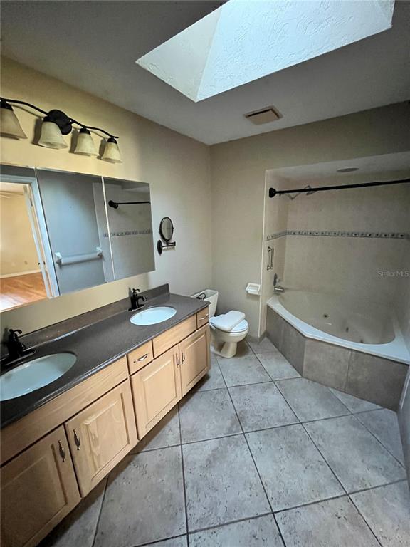 941 Mill Rd Lane Port Orange, FL 32127 - Photo 12 of 24 a bathroom with a sink a toilet and bathtub