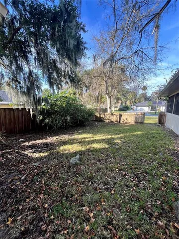 a view of a yard with large trees