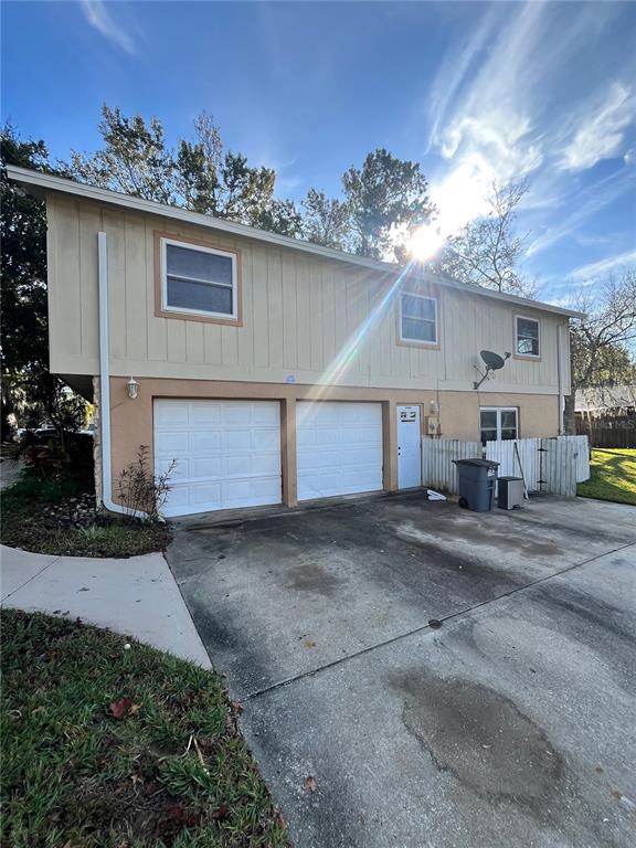 941 Mill Rd Lane Port Orange, FL 32127 - Photo 3 of 24 a front view of a house with a yard and garage