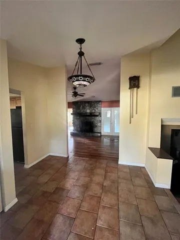 a living room with a fireplace furniture and a ceiling fan