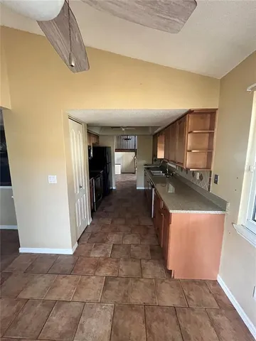 a kitchen with stainless steel appliances granite countertop a refrigerator and a stove