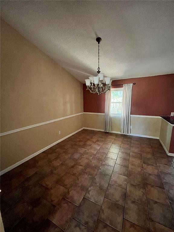 941 Mill Rd Lane Port Orange, FL 32127 - Photo 7 of 24 a view of a livingroom with a chandelier fan and entryway