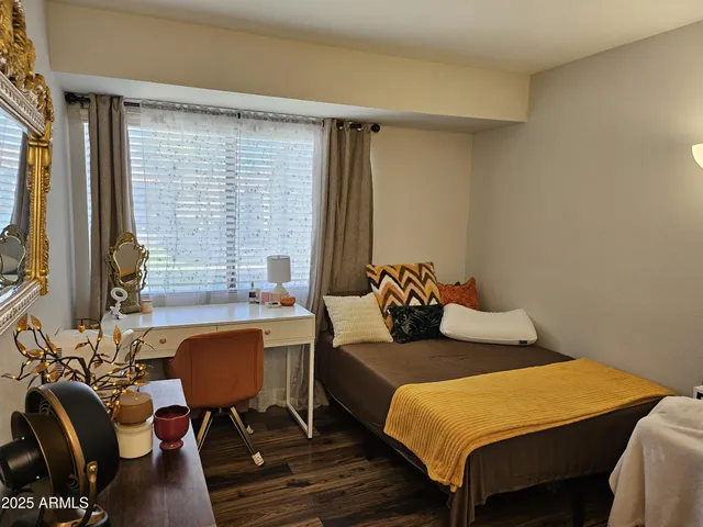 a bedroom with bed chair and window