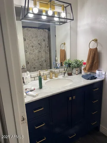 a bathroom with a sink vanity and a mirror