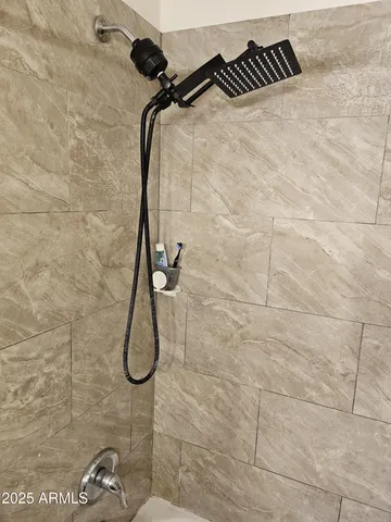 a bedroom with a bed wooden floor and window