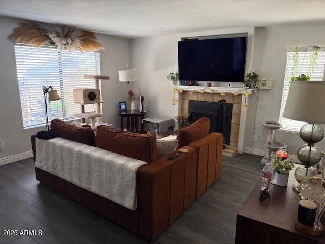 a living room with furniture a flat screen tv and a fireplace