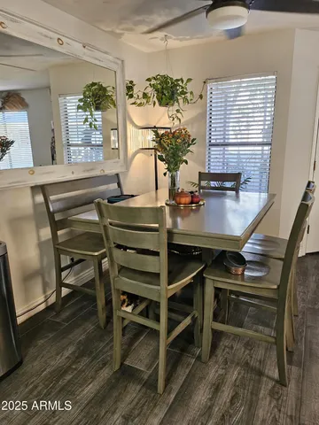 a view of a dining room with furniture and a potted plant