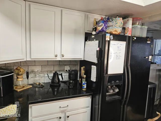 a kitchen with a refrigerator and cabinets