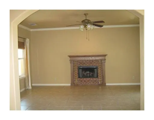 a view of a livingroom with a fireplace and a ceiling fan