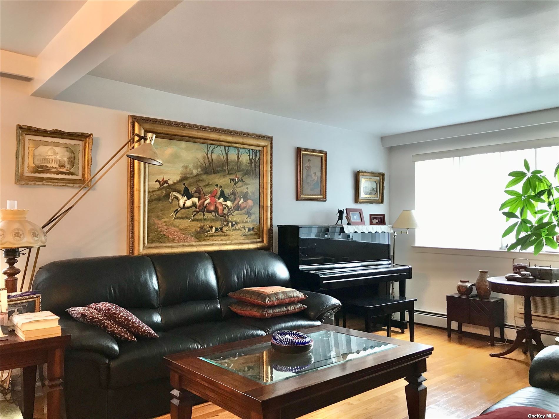 170-15 84th Drive Queens, NY 11432 - Photo 4 of 15 a living room with furniture and a piano