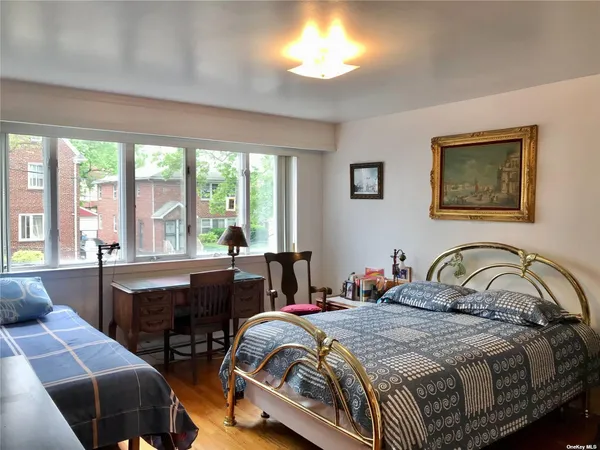 a bedroom with a bed and a large window