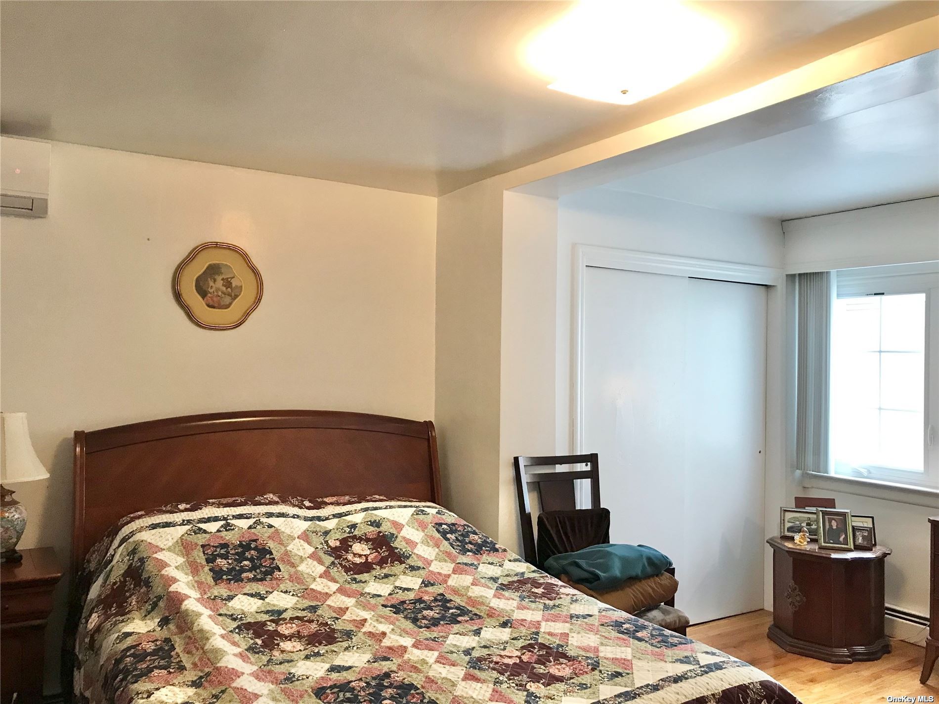 170-15 84th Drive Queens, NY 11432 - Photo 9 of 15 a bedroom with a bed and a dresser