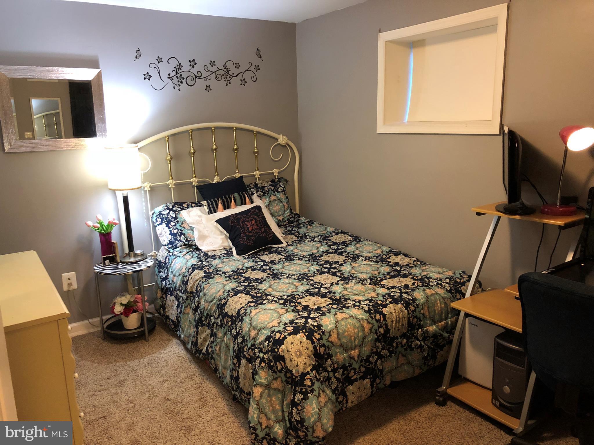 8989 Centerway Road Gaithersburg, MD 20879 - Photo 13 of 26 a bed sitting in a room next to a window
