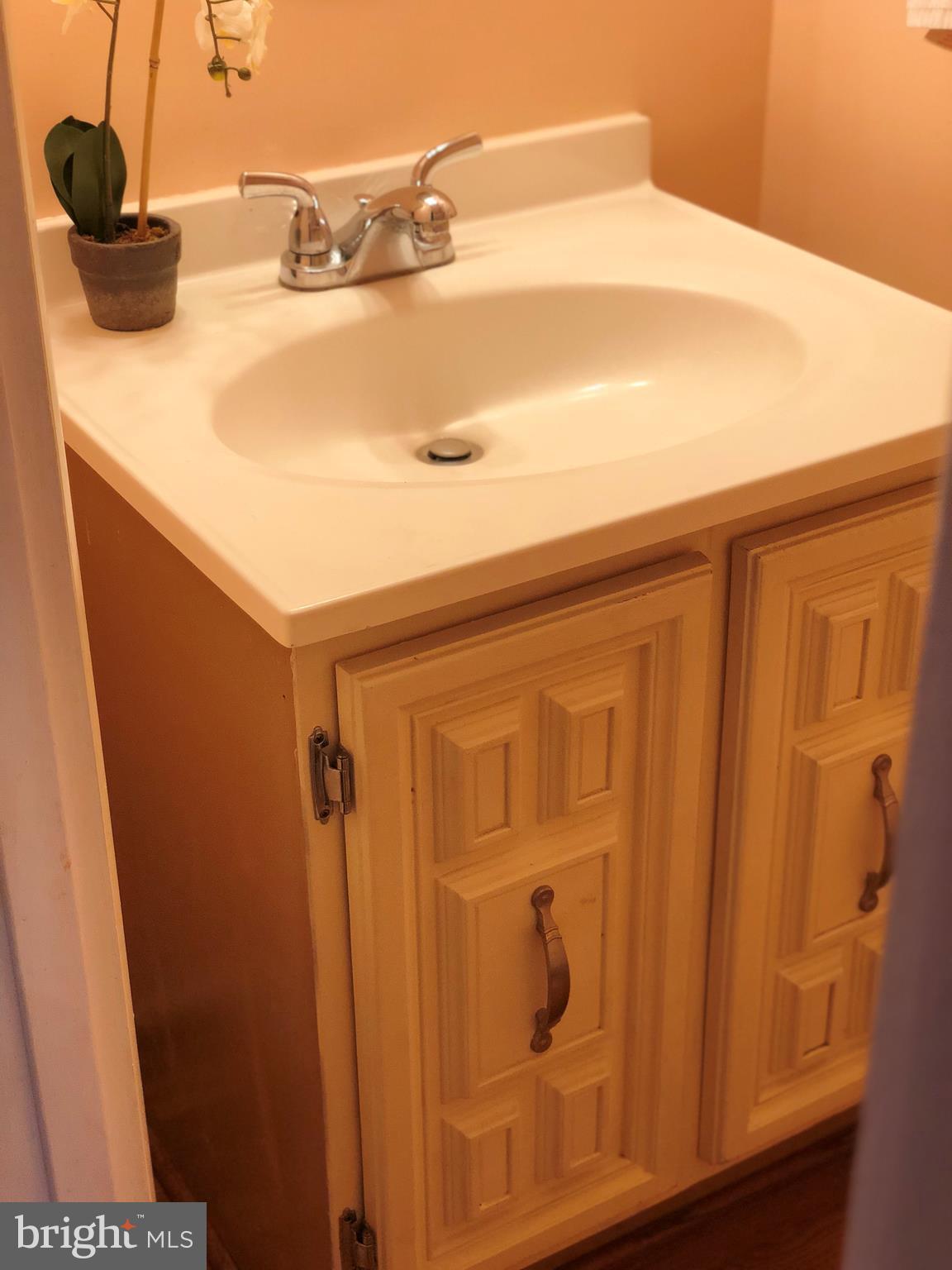 8989 Centerway Road Gaithersburg, MD 20879 - Photo 20 of 26 a bathroom with a sink and a mirror