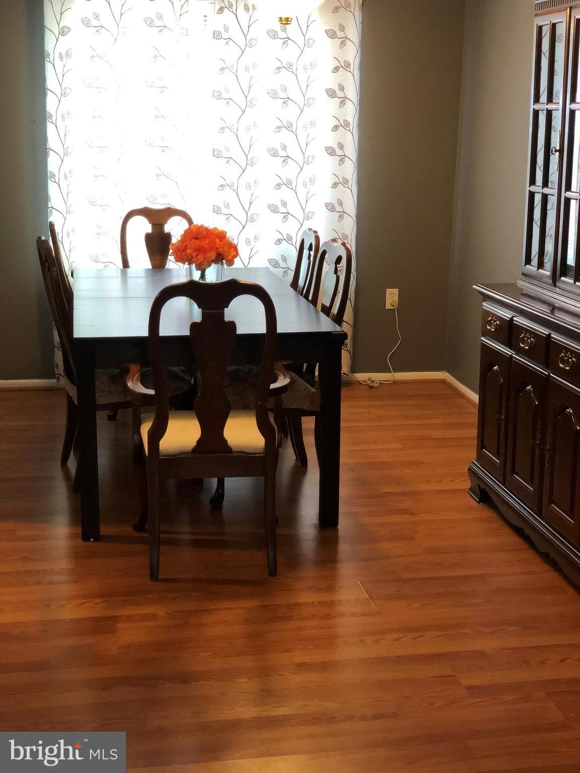 8989 Centerway Road Gaithersburg, MD 20879 - Photo 21 of 26 a view of a dining room with furniture and chandelier