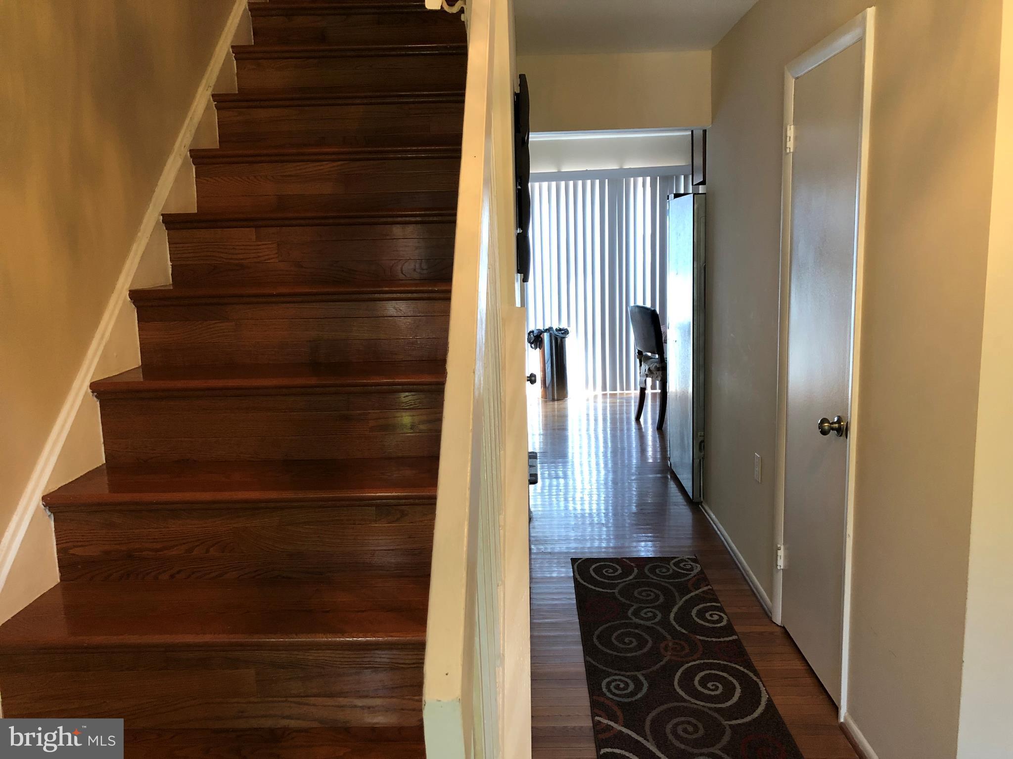 8989 Centerway Road Gaithersburg, MD 20879 - Photo 24 of 26 a view of entryway and hall with wooden floor