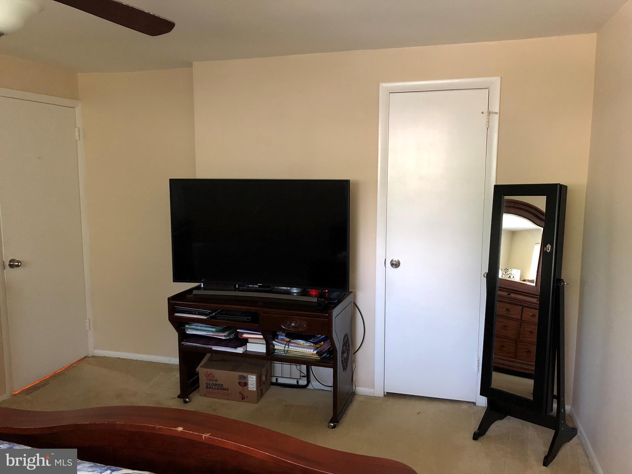 8989 Centerway Road Gaithersburg, MD 20879 - Photo 26 of 26 a room with furniture and wooden floor